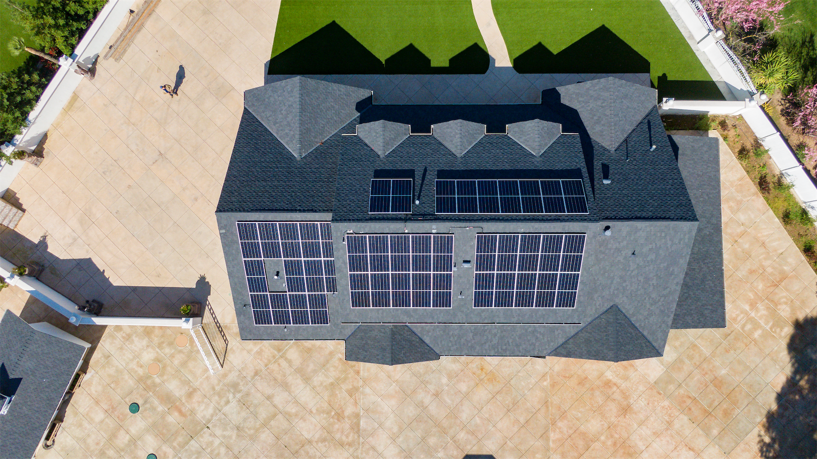 Areal image of a house with solar panels on it.